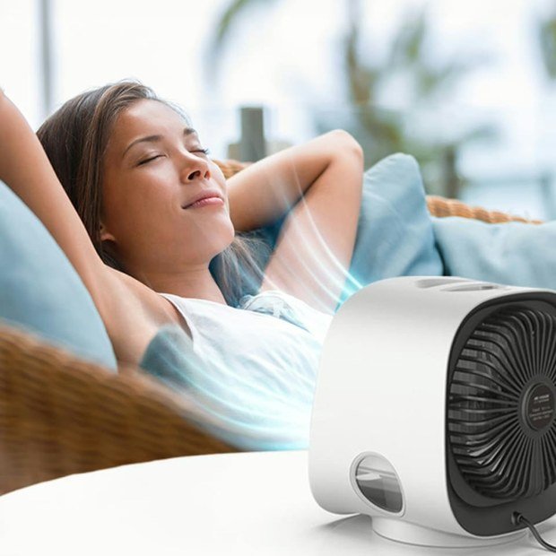 AiraBreeze portable air cooler delivering a personal cooling zone in a relaxed home setting — compact evaporative cooler review